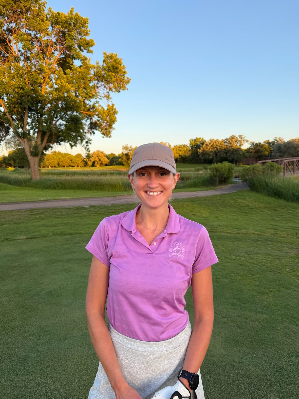 Amy, founder of Stance Golf Co, at the course at sunset